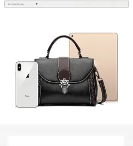 Black pebbled leather crossbody bag size comparison with tablet and smartphone