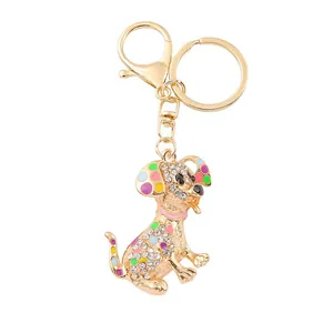Golden Dalmatian keychain with sparkling white rhinestones and colorful enamel accents