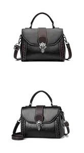 Detail view of the black leather woven texture and metal buckle on this small handbag