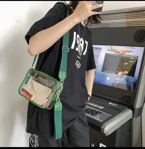 Close-up of green transparent PVC crossbody bag with wide strap and inner pouch