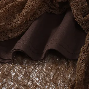 Detail shot of intricate brown lace fabric with soft lining and durable hem stitching