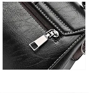 Detail of black leather bag showing contrast stitching and premium silver metal zipper