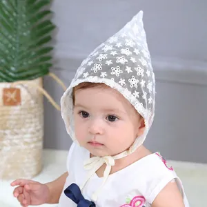 Detailed view of white floral lace baby bonnet with delicate embroidery and ties