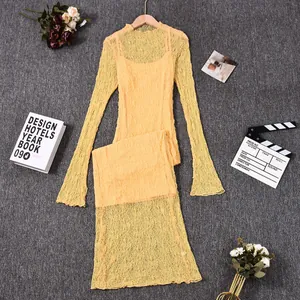 Detailed view of yellow lace long-sleeved dress with sheer texture and matching lining