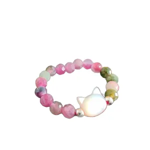 Handmade beaded ring featuring multi-color tourmaline and a white pearl cat head bead