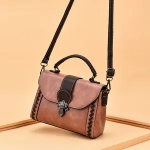 Retro brown crossbody bag with woven edges and vintage bronze metal buckle
