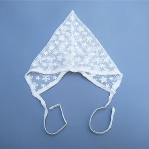 Detailed view of a white lace baby kerchief with delicate floral eyelet embroidery