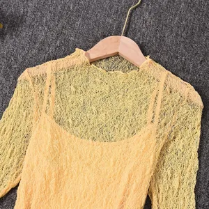 Detail of yellow long sleeve lace hollow-out top with inner camisole set