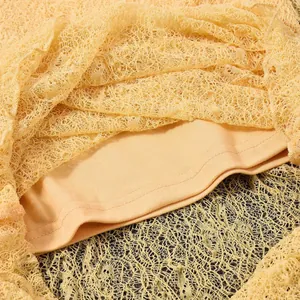 Detailed macro view of the delicate lace fabric and comfortable lining on a slim dress