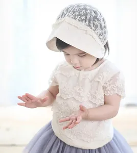 Close-up of delicate hollow embroidery and lace ruffles on this vintage baby bonnet