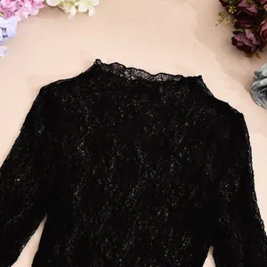 Close-up of black floral lace fabric with semi-transparent hollowed out embroidery details
