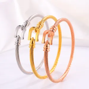 Detailed cable texture and horseshoe buckle on steel, gold and rose gold bangles