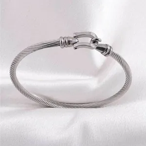 Detailed macro view of the silver cable twist bracelet with a U-shaped horseshoe buckle