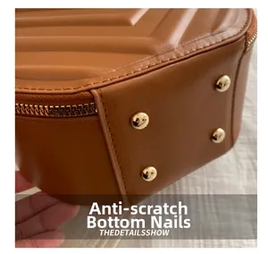 Detail of the brown quilted leather bag base with four golden protective metal studs