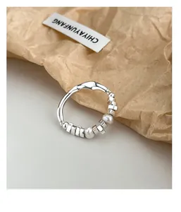 Macro view of S925 silver wave ring with freshwater pearl and irregular beads