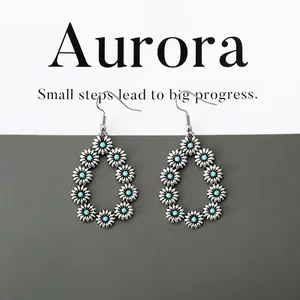 Detail of silver drop earrings with daisy flowers and turquoise beads on Aurora card