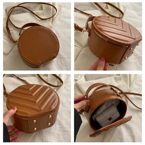 Detail view of brown vintage round crossbody bag showing quilting and metal feet