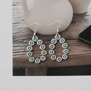 Vintage silver hollow teardrop earrings with turquoise flower design on stone