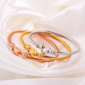 Three minimalist stainless steel horseshoe buckle cable bracelets in gold and silver finish
