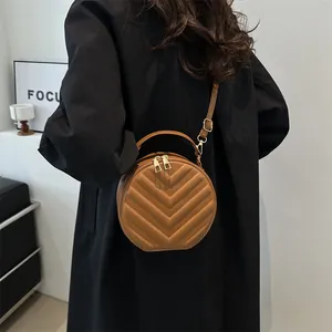 Fashionable caramel brown round PU leather crossbody bag with V-quilted pattern and top handle