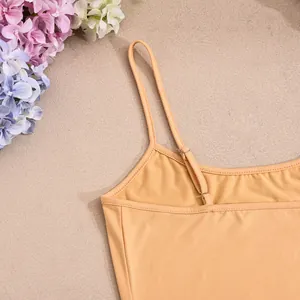 Detail of sewing on orange camisole strap showing high quality elastic fabric texture