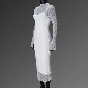 Detailed close-up of the delicate floral lace pattern on a white long sleeve mesh dress