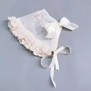 Detailed view of baby lace bonnet featuring delicate mesh and large satin bow