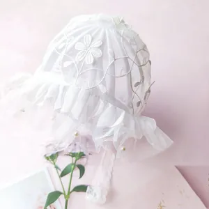 Close-up of baby lace bonnet with floral embroidery and pearl beads for photography