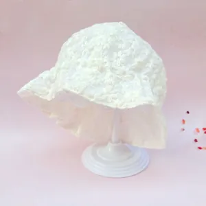 Detailed view of baby lace bonnet featuring delicate floral embroidery and wavy edges