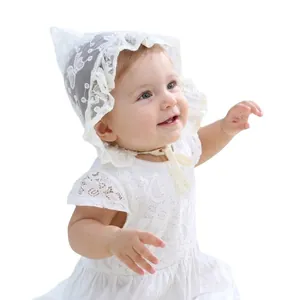 White lace baby bonnet and dress set with delicate butterfly pattern and ruffle details