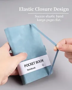 Detail showing elastic strap closure on light blue A6 textured leather notebook