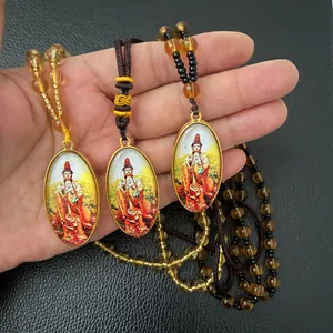 Detailed macro view of three Guanyin Buddha pendants with gold frames and beads