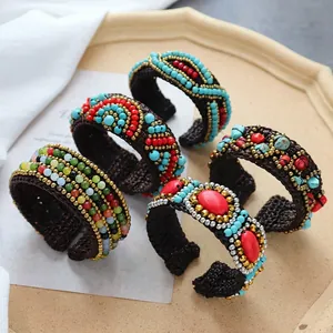 Macro shot of handmade bohemian woven bracelets with colorful beads and natural stones