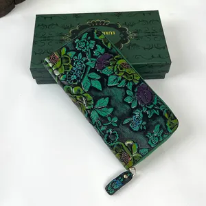 Detail of vintage embossed leather wallet with 3D floral patterns and matching gift box