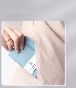 Blue pocket book notebook with elastic band shown fitting into a clothing pocket