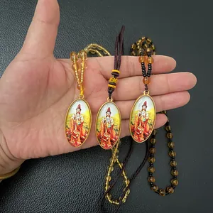 Close-up of three Guanyin Buddha oval pendants with colorful portraits and beaded chains