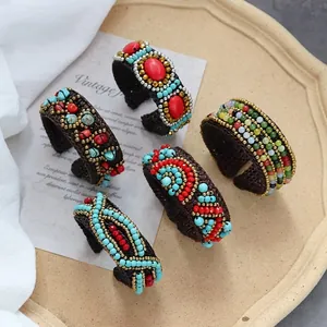 Detail of five-piece Bohemian beaded bracelets set with turquoise and coral accents