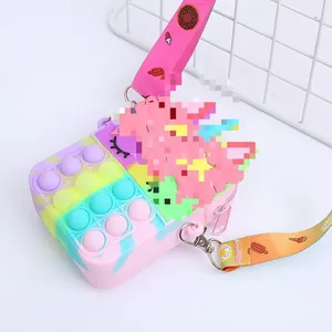 Detail view of colorful silicone push bubble crossbody bag with printed strap