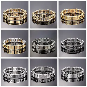 Close-up of assorted stainless steel bike chain bracelets with engraved cross details