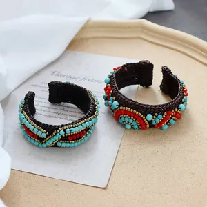 Handmade Bohemian woven bracelet with turquoise and red beads in ethnic tribal style