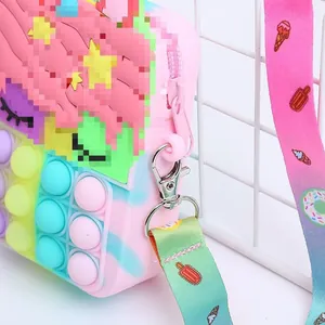 Detail view of pink silicone pop purse with rainbow shoulder strap and zipper