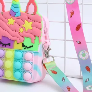 Detail view of pink silicone pop purse with rainbow shoulder strap and zipper