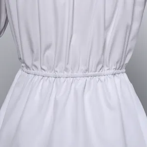 Macro view of white shirred elastic waist detail on chiffon summer blouse