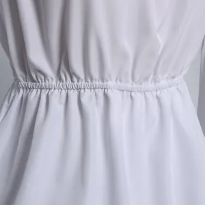 Close-up of the white off-shoulder top showing elastic smocked waist and fine fabric texture