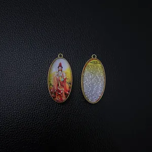 Macro detail of the Great Compassion Mantra text on the oval Buddhist pendant