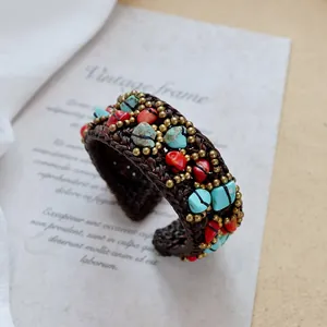 Detailed view of handmade bohemian braided bracelet with turquoise and brass beads