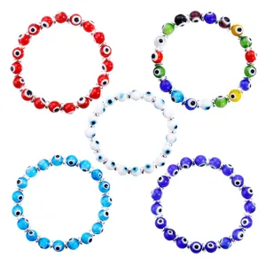 Detail view of colorful Evil Eye beaded bracelets with Nazar beads and silver spacers