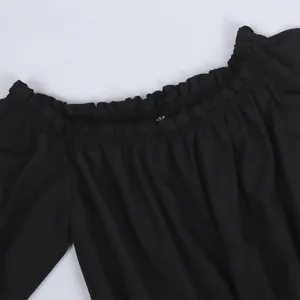 Close-up of off-the-shoulder elastic neckline with ruffle trim on black summer top