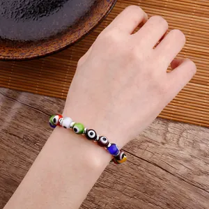 Handmade evil eye beaded bracelet with colorful charms worn on the wrist for protection