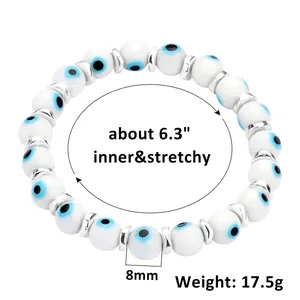 Macro detail of 8mm Evil Eye beads with silver spacers on a stretchy bracelet